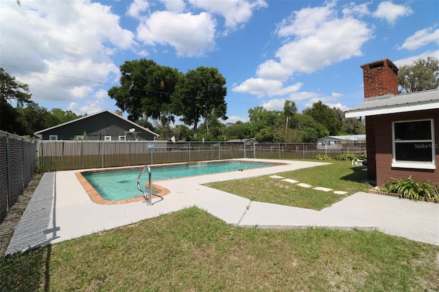 view of swimming pool featuring a yard and a patio