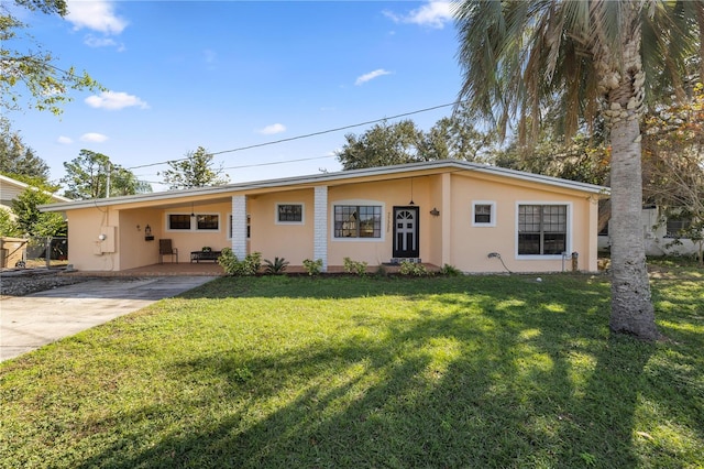 ranch-style house featuring a carport and a front lawn