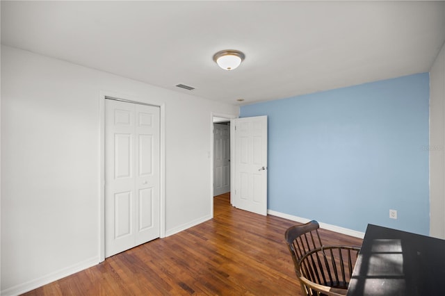 unfurnished office featuring dark hardwood / wood-style flooring