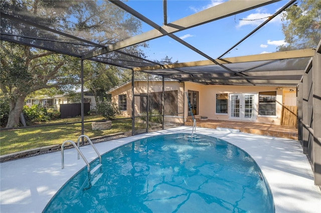 view of swimming pool featuring a lawn, glass enclosure, and a patio