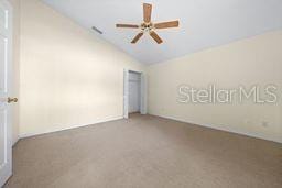 unfurnished bedroom featuring ceiling fan and lofted ceiling