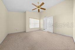 spare room with ceiling fan and light carpet