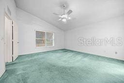 unfurnished room with carpet flooring, ceiling fan, and vaulted ceiling