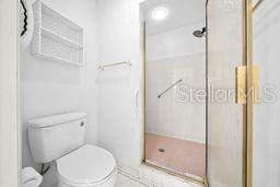 bathroom with toilet and walk in shower