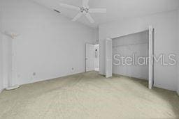 unfurnished bedroom with ceiling fan and light carpet