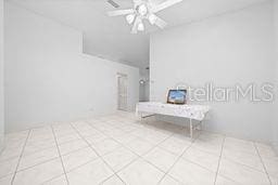 tiled empty room with ceiling fan