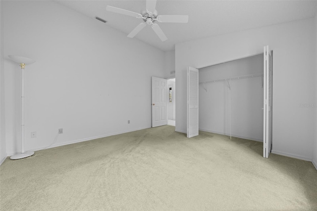 unfurnished bedroom featuring visible vents, ceiling fan, carpet, a high ceiling, and a closet