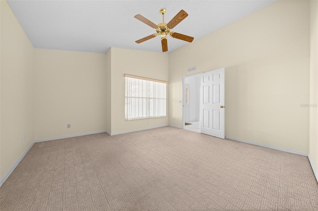 unfurnished room with light carpet, ceiling fan, lofted ceiling, and baseboards