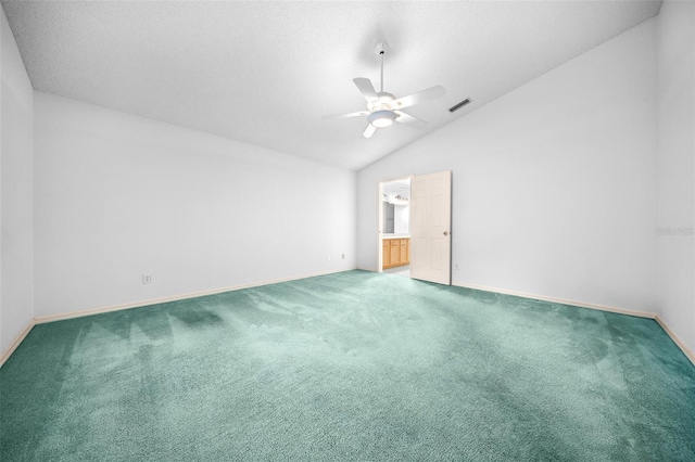 empty room featuring visible vents, baseboards, lofted ceiling, carpet flooring, and a ceiling fan