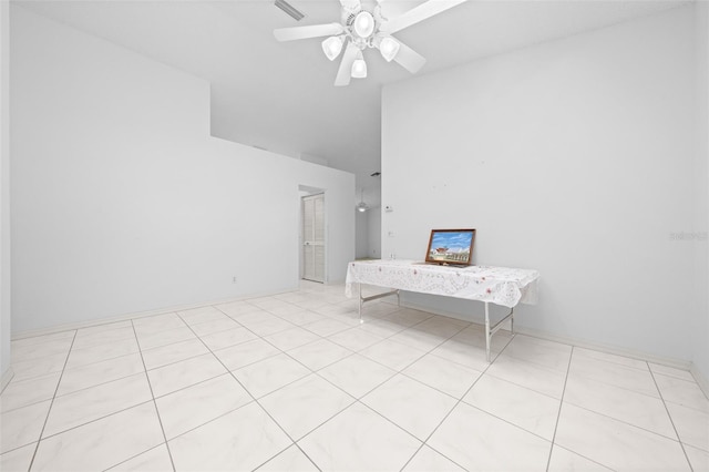 spare room featuring light tile patterned floors, a ceiling fan, visible vents, and high vaulted ceiling