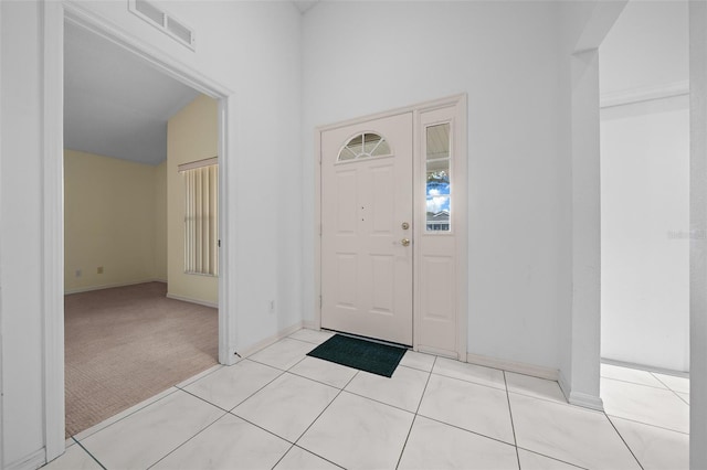9260 SW 92nd Place Rd, Ocala, FL 34481 - foyer entrance featuring light tile patterned floors, light colored carpet, visible vents, and baseboards