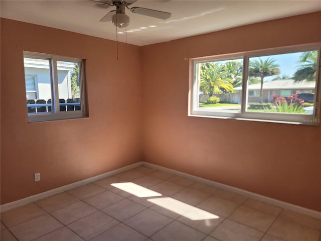 unfurnished room featuring ceiling fan and light tile patterned floors