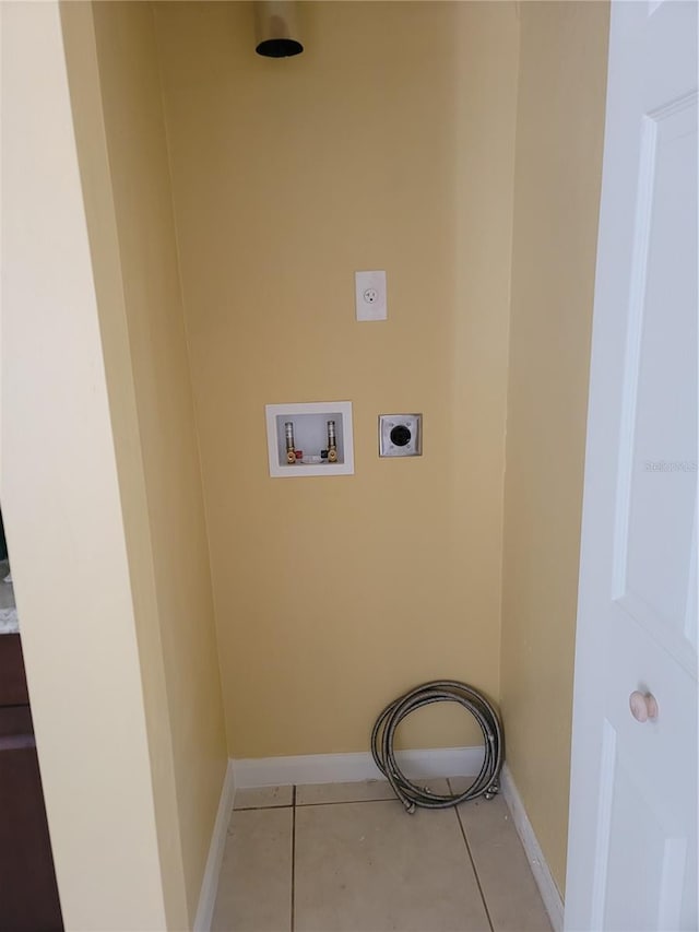 clothes washing area with tile patterned floors, hookup for a washing machine, and hookup for an electric dryer