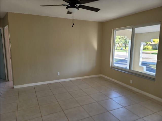 tiled empty room with ceiling fan