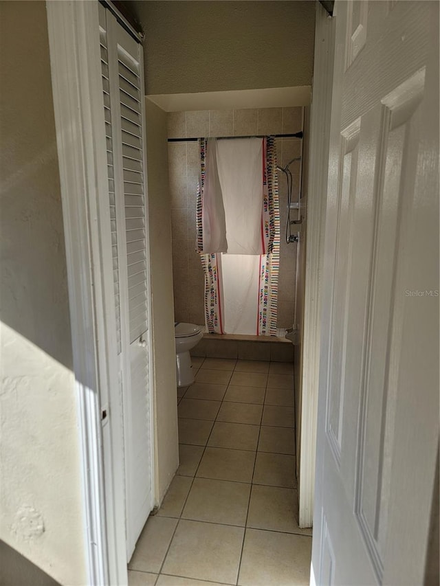 bathroom featuring tile patterned flooring and toilet