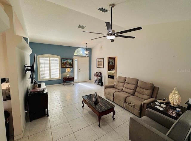 tiled living room with ceiling fan and lofted ceiling