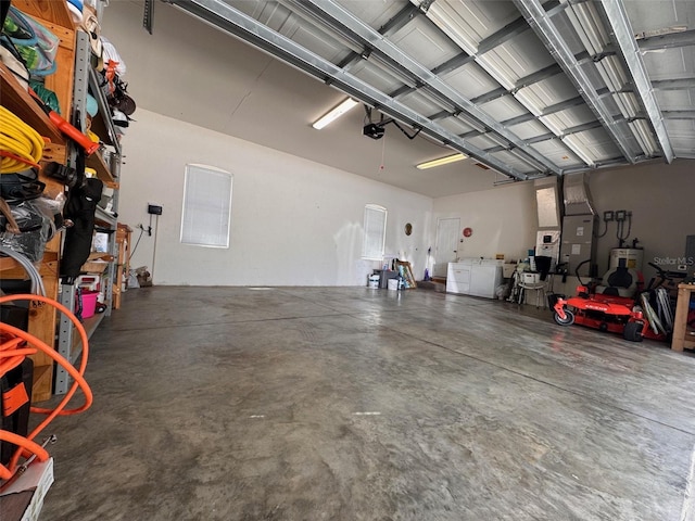 garage featuring electric water heater, heating unit, and a garage door opener