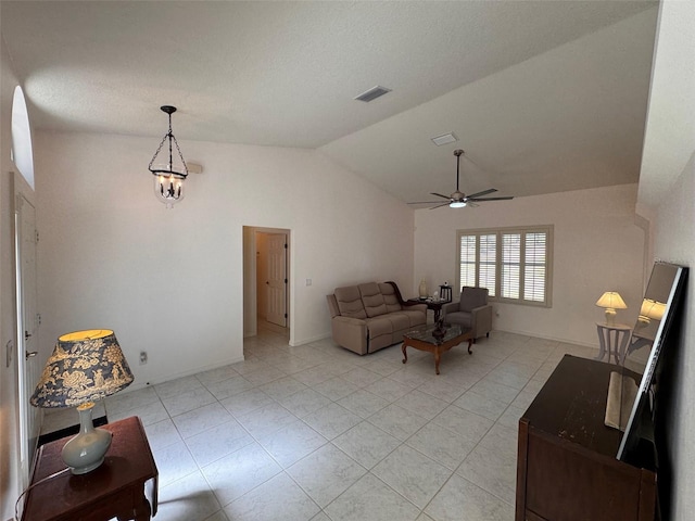 living room with ceiling fan, light tile patterned floors, and vaulted ceiling