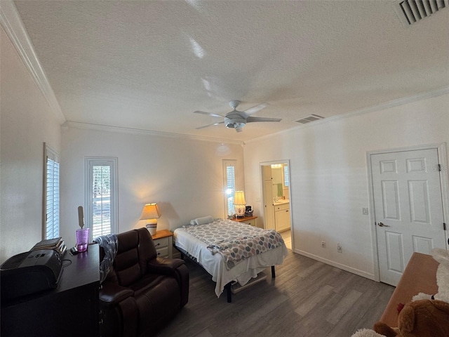 bedroom featuring hardwood / wood-style floors, a textured ceiling, ceiling fan, crown molding, and connected bathroom