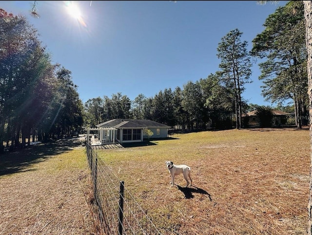 exterior space with a rural view and a front yard