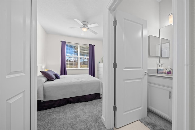 carpeted bedroom with ceiling fan and a textured ceiling