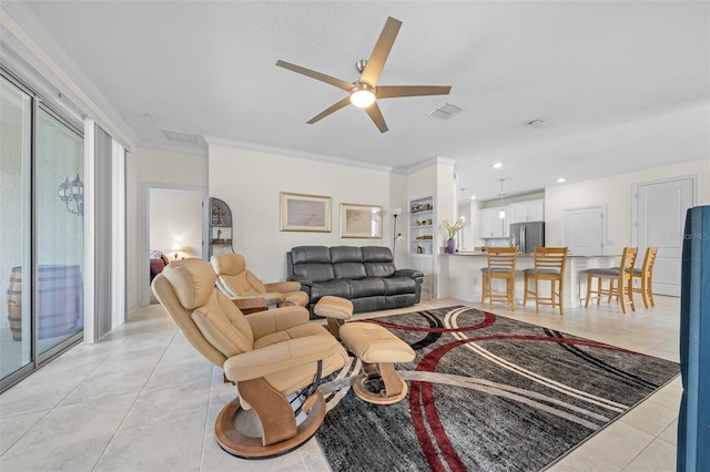 living room featuring built in shelves, light tile patterned flooring, crown molding, and ceiling fan