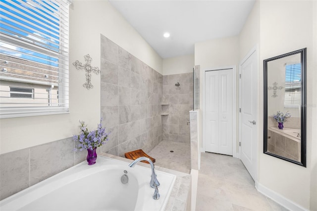 bathroom featuring tile patterned flooring, a wealth of natural light, and independent shower and bath