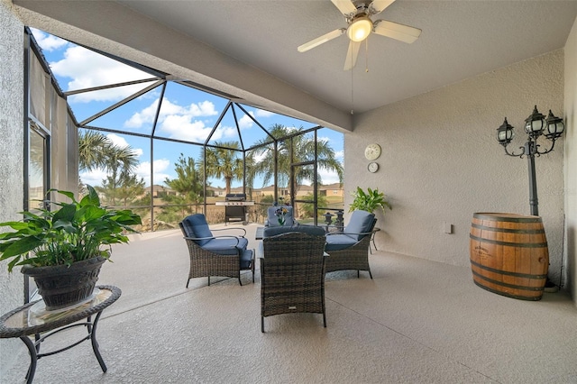 view of patio featuring ceiling fan and a lanai