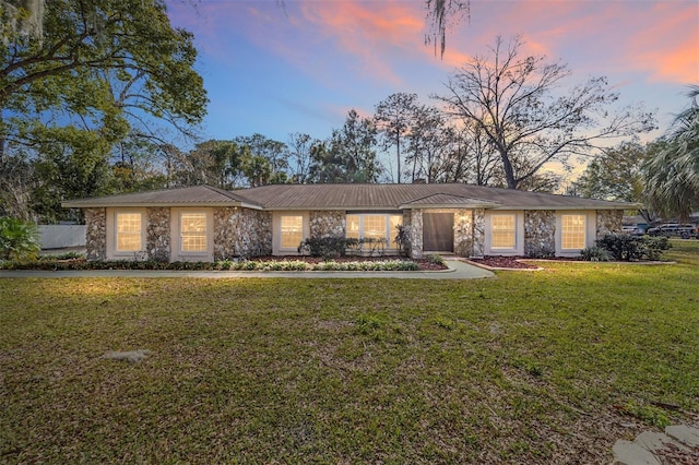 ranch-style house with a yard