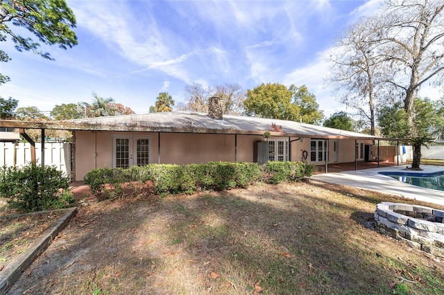 rear view of property with french doors and a patio