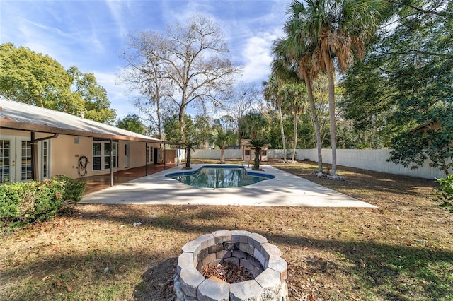 view of pool featuring an outdoor fire pit and a patio