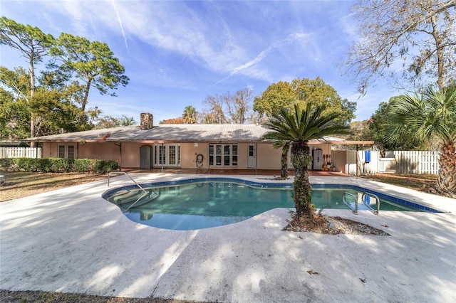 view of pool featuring a patio area and french doors