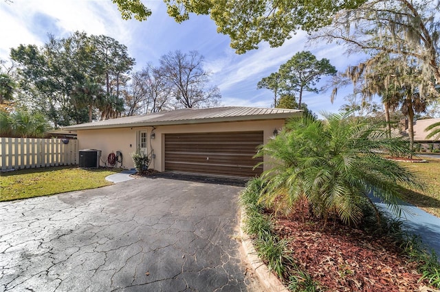 view of front of house featuring central AC unit and a garage