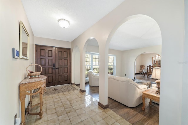 foyer with a textured ceiling and light wood-type flooring