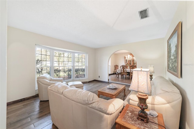 living room with dark hardwood / wood-style flooring and a textured ceiling