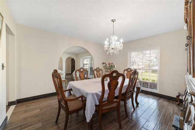 dining space featuring a textured ceiling and a notable chandelier