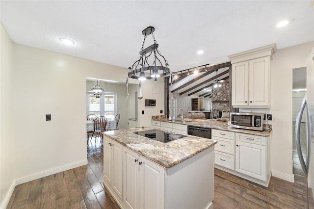 kitchen featuring a center island, hanging light fixtures, light stone counters, dark hardwood / wood-style floors, and black appliances