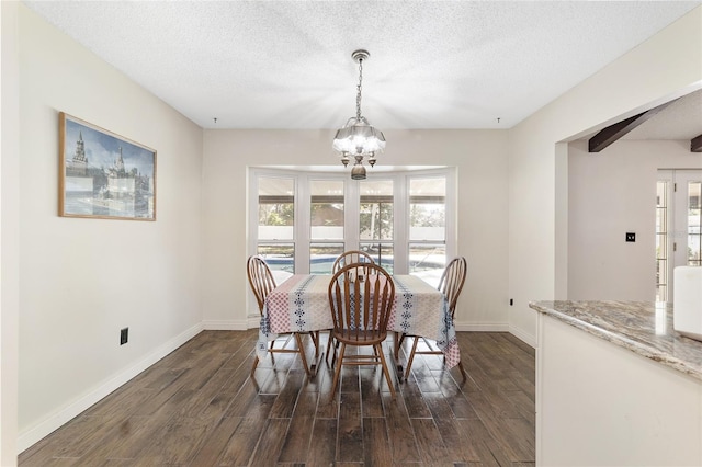 dining space featuring a chandelier and a textured ceiling