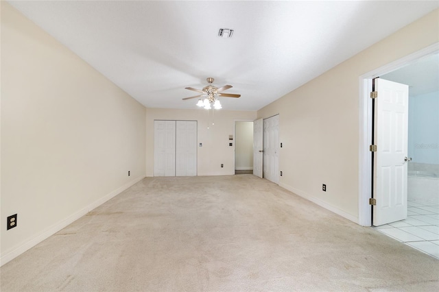 unfurnished bedroom featuring ceiling fan and light carpet