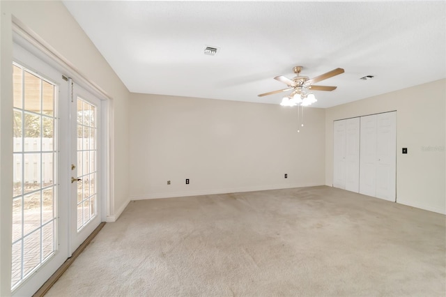 unfurnished bedroom with light carpet, access to outside, french doors, ceiling fan, and a closet