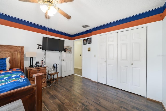 bedroom featuring ceiling fan, a closet, and dark hardwood / wood-style floors