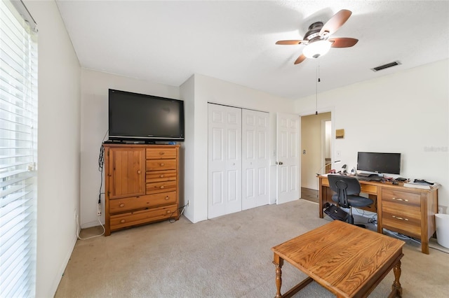 carpeted office featuring ceiling fan