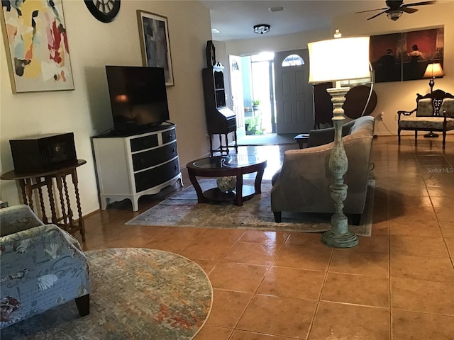 living room featuring tile patterned floors and ceiling fan