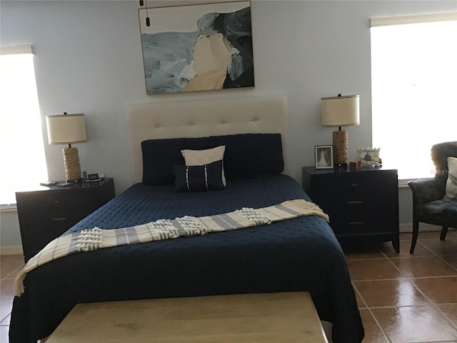 tiled bedroom with multiple windows