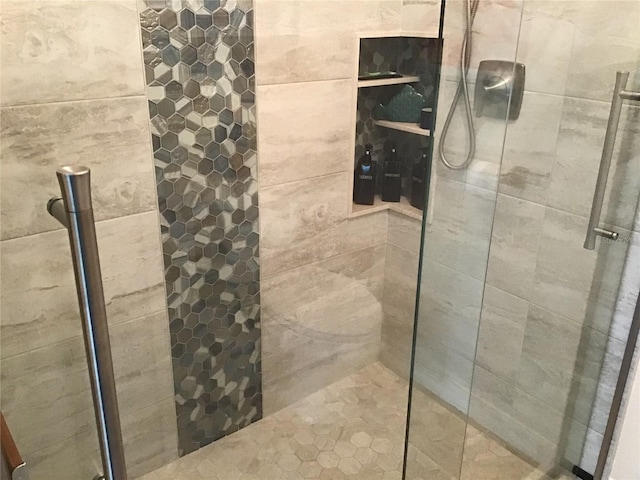 bathroom with tiled shower