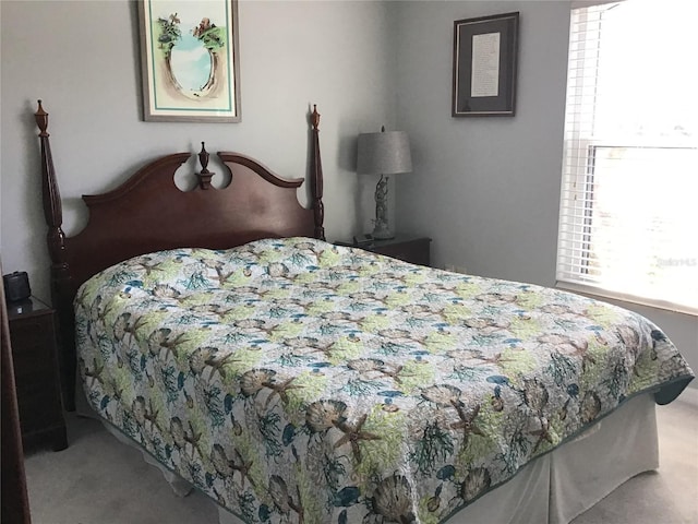 bedroom featuring light colored carpet