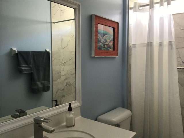 bathroom featuring vanity, toilet, and walk in shower