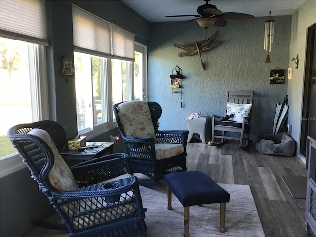 sunroom featuring ceiling fan and a wealth of natural light