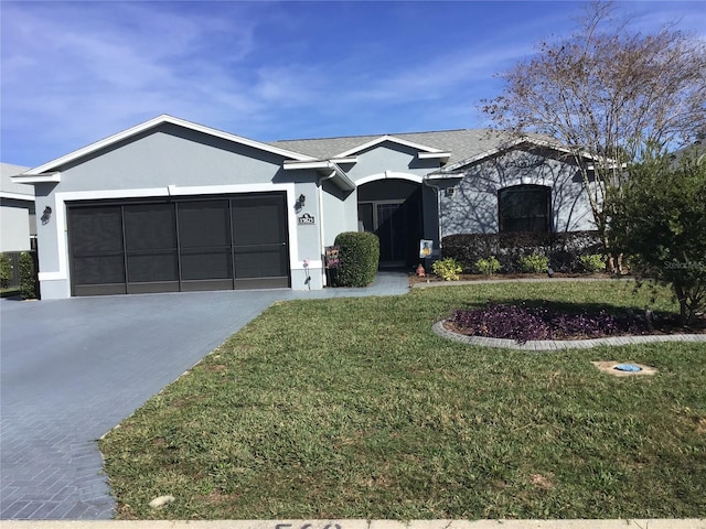 ranch-style home featuring roof with shingles, driveway, stucco siding, a front lawn, and a garage