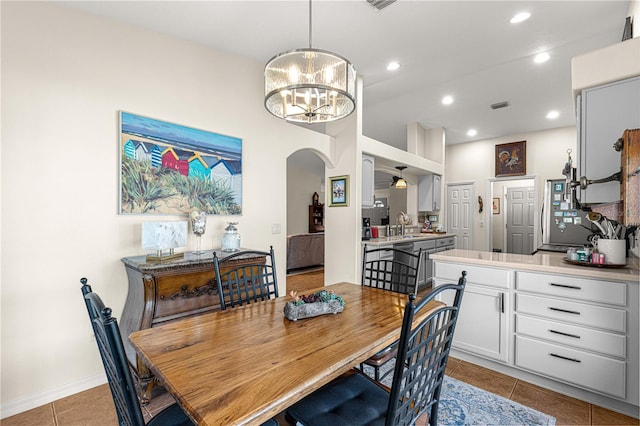 dining room featuring visible vents, recessed lighting, arched walkways, light tile patterned flooring, and a chandelier